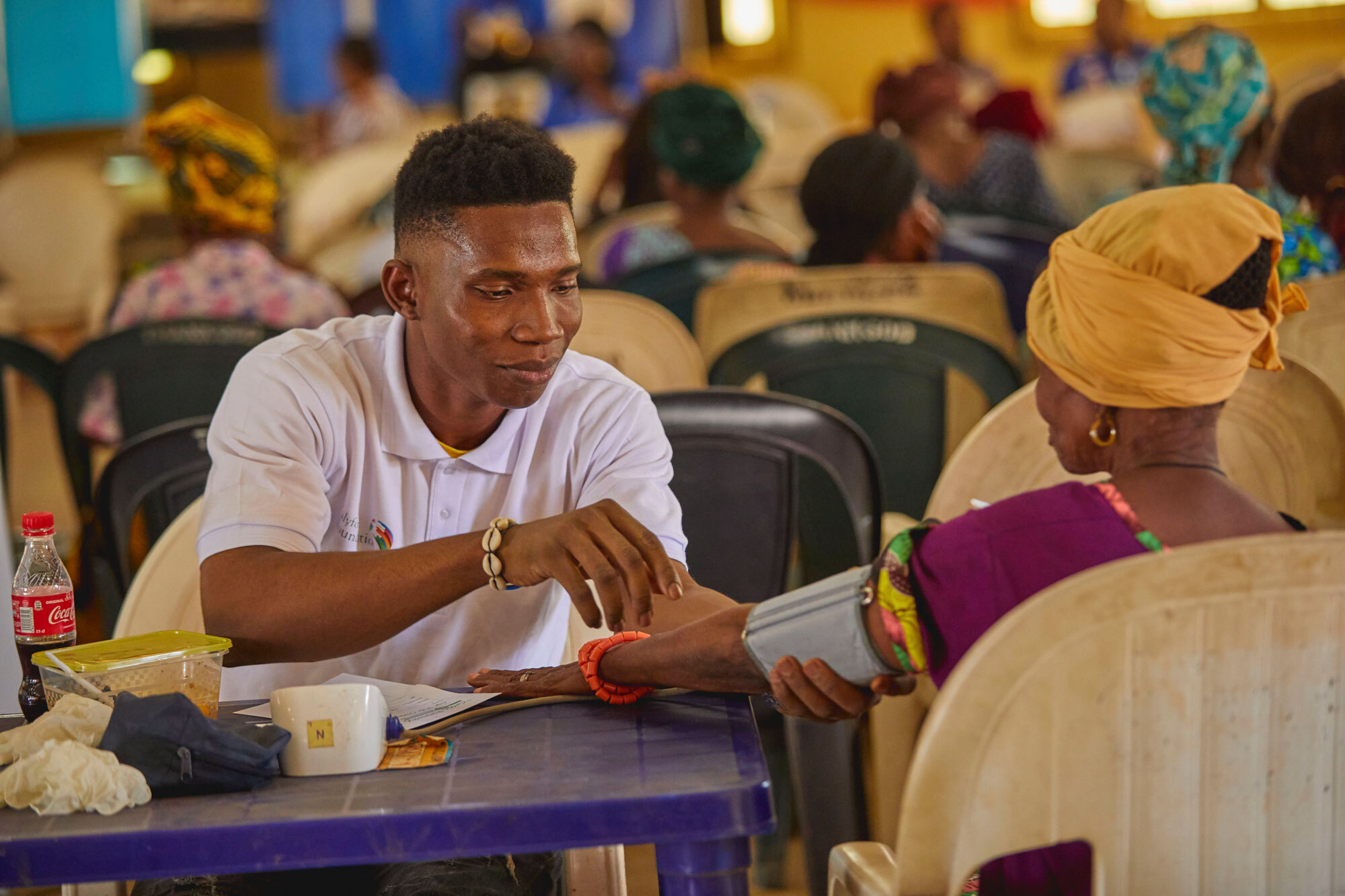 Lilyford A medical volunteer taking the vitals of a beneficiary